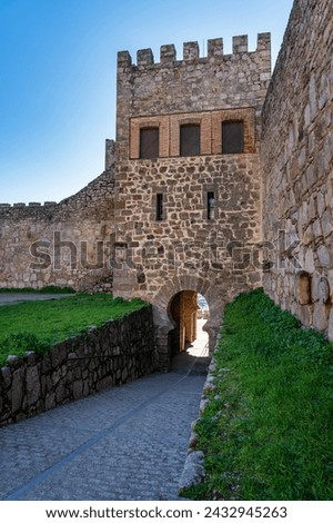 Stone tower leading to the medieval citadel castle of the monumental city of Trujillo, Spain.