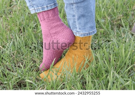 A person's legs in grass
