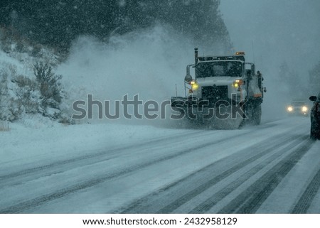 Caltrans snowplows work to clear snow off U.S. 395 in Mono County during the latest winter storm in the Sierra Nevada of California. Royalty-Free Stock Photo #2432958129