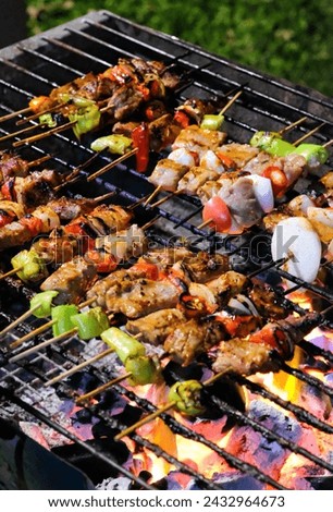 Pictures of a barbecue grilling on a charcoal grill have some pieces that are already burnt.  Some pieces were cooked just right.  and some pieces are not yet cooked