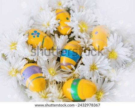 Decorative Easter eggs lie in white flowers. Church Christian holidays, Christianity, Easter background.
