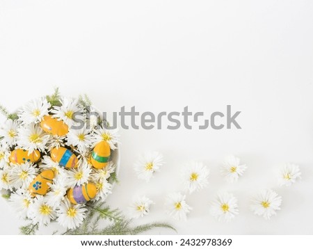 Decorative yellow Easter eggs and white flowers on a white background with copy space. Church Christian holidays, Christianity, Easter background.