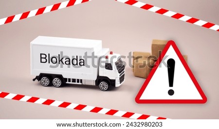 A white toy truck or van and a no-passing sign with the text Block of the Polish customs border.