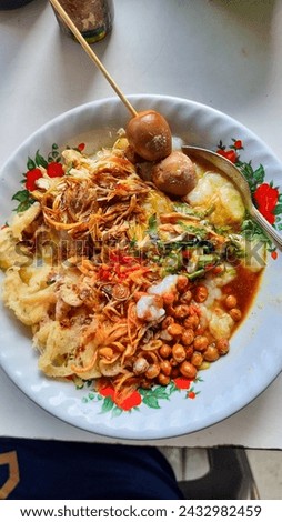 Traditional Food of indonesia called Bubur Ayam with topping onion and puyuh birds egg Royalty-Free Stock Photo #2432982459