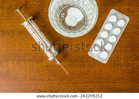 Cure the disease, couple of tablets dissolve in a glass of water and a syringe. Focus on the glass of water