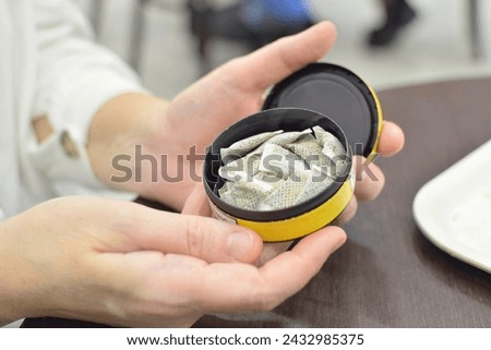 A box of snus pads replaces smokeless cigarettes. Swedish popular trend. Royalty-Free Stock Photo #2432985375