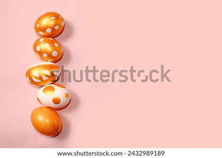 Decorated golden Easter eggs on a pink background. . Happy Easter background,banner. Creative painting of eggs at home. Minimal holiday concept, idea of simple drawings