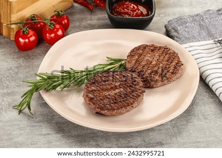 Grilled two beef burger cutlet served rosemary