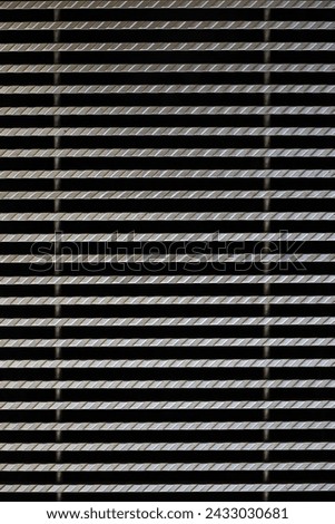 Background material photo showing a close-up of iron grating from above