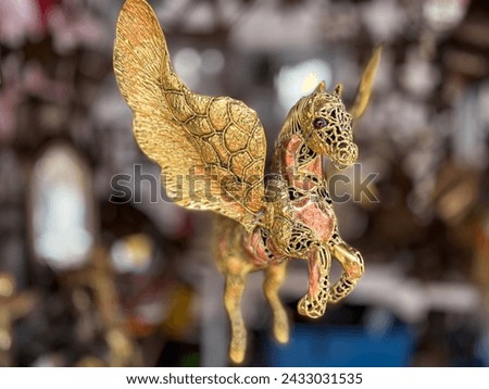 Golden brass metal Pegasus local Mexican market handicraft art for home or patio decoration 