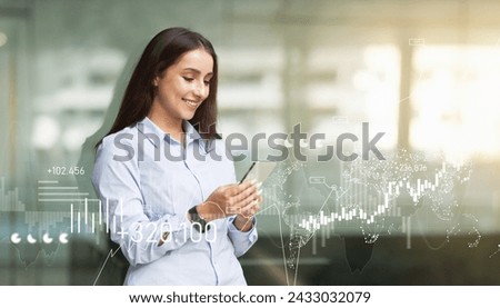 Young businesswoman in a light blue shirt uses her smartphone, with digital financial graphics and world map overlay, indicating global business connectivity, panorama. Work, business