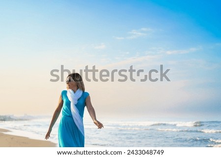 Beach holidays - woman walking on beach 