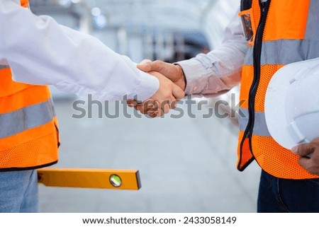 Team of engineer is having and handshake after done inspecting the construction project for modern architecture and real estate development hand over concept Royalty-Free Stock Photo #2433058149