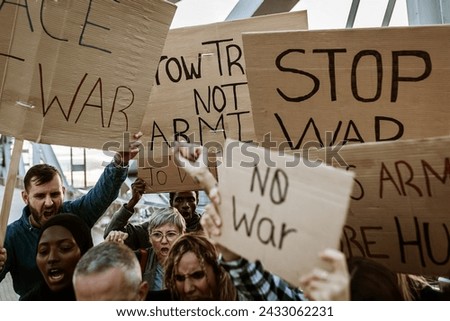Group of activist people marching for world peace. Diverse demonstrators holding banners and posters protesting against war and violence. No war protest manifestation concept.