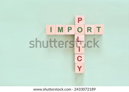 Import policy concept. Crossword puzzle flat lay typography in green background.	