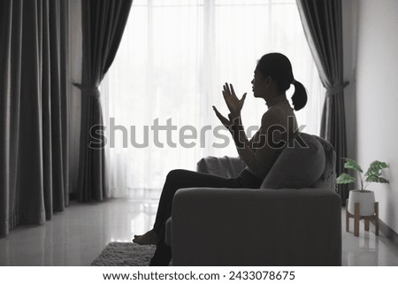 Silhouette of Woman hands praying for blessing from god. Praying hands with faith in religion and belief in God on blessing background.