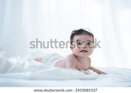 A baby crawling in the living room at home Royalty-Free Stock Photo #2433085337