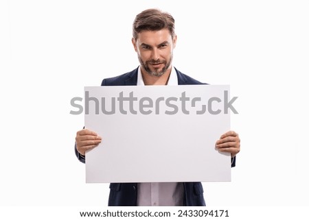 Handsome man holds the sign, blank card. Placard ready for your product. Portrait of man showing blank sign board on studio isolated background. Empty blank board. Advertising and copy space concept.