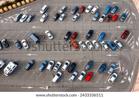 Paved outdoor parking with white road markings, infrastructure filled with cars, view from copter. Royalty-Free Stock Photo #2433106511