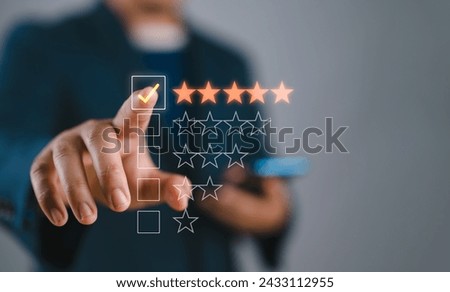 Hand touching and doing mark to five yellow stars on black background, the best customer satisfaction and evaluation for good quality product and service. Royalty-Free Stock Photo #2433112955