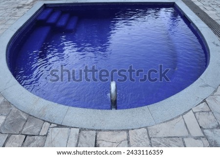 sulphurous, Swimming pool steps with clear water surface background, nobody. empty pool, underwater pattern blue background with grid tiles. Overhead view. Summer backdrop. pouring metal pipe Borjomi