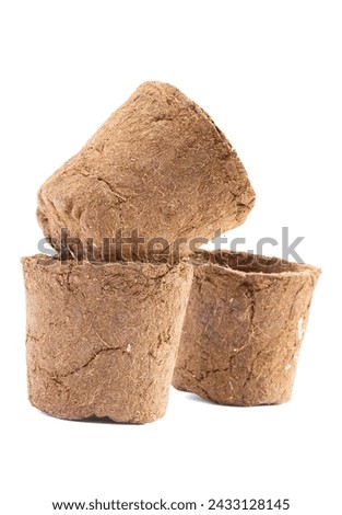 Potted plant, love the earth, love the environment Brown coconut coir pot on white background. Royalty-Free Stock Photo #2433128145