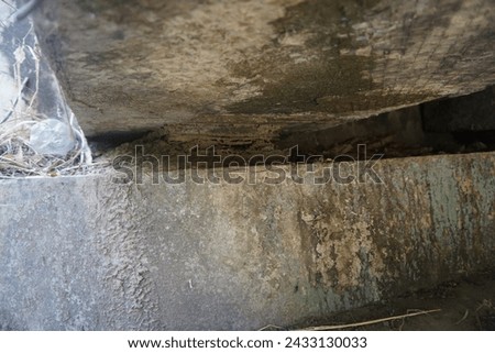 Indonesia, East Java. Under the bridge which is starting to become fragile, and there is rubbish, the condition of the building is also starting to deteriorate.