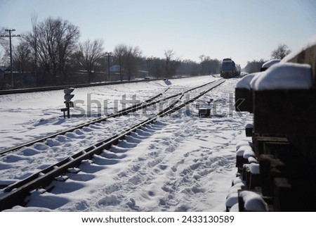 An electric locomotive with a freight train is traveling on rails. Royalty-Free Stock Photo #2433130589