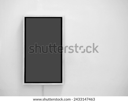 Mockup vertical rectangle lightbox isolated on white wall background with copy space. Mockup blank hanging light box showcase with black frame for information, poster, text message and advertisement.