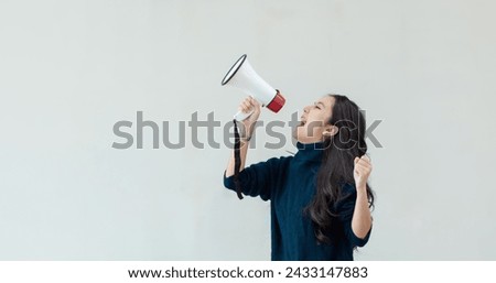 Happy young asian woman using a megaphone on white background, Advertising and public relations announcements concept.