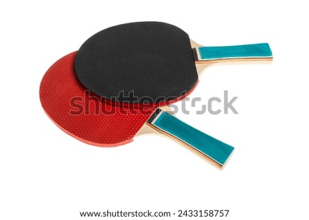 Red and black table tennis rackets highlighted on a white background with a cropping outline. Sports equipment for ping pong in a minimalist style. Flat surface, top view. Royalty-Free Stock Photo #2433158757