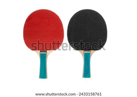 Red and black table tennis rackets highlighted on a white background with a cropping outline. Sports equipment for ping pong in a minimalist style. Flat surface, top view. Royalty-Free Stock Photo #2433158761