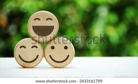 Wooden smile emoji with natural bokeh background. International Day of Happiness and mental health concept. Royalty-Free Stock Photo #2433161709