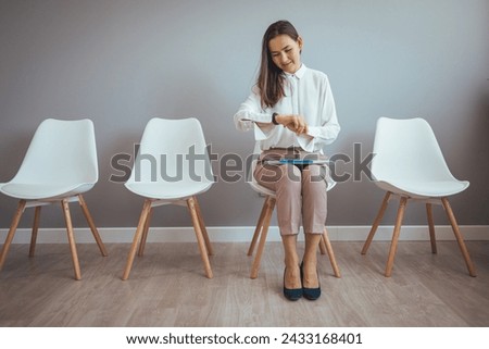 Portrait, laptop and woman in waiting room, interview or recruitment, hiring or office job. Computer, hr and happiness of business person or Asian female from Japan sitting on chair for employment.