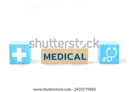 Wooden block with the word MEDICAL and medical icons. Health care, health insurance and treatment concept.