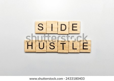 Wooden cube with text side hustle isolated over white background. Side hustle concept. Side hustle sign on a plank table.