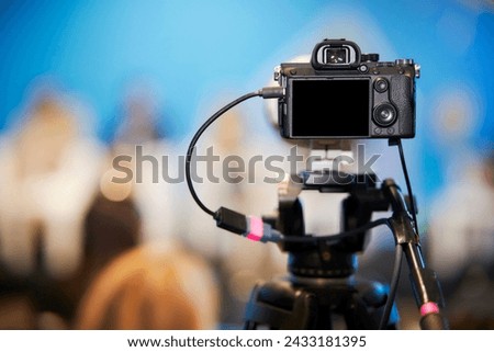 mirrorless camera at the conference, forum. mirrorless camera with a tripod take pictures of speakers at the conference. Video recording of the speaker's speech at the forum. mirrorless camera. Royalty-Free Stock Photo #2433181395