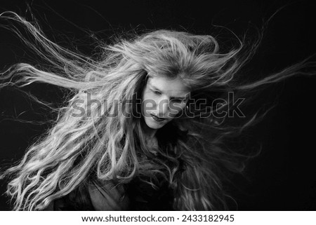She has totally wild, blown-with-the-wind hair and is completely in her own rhythm