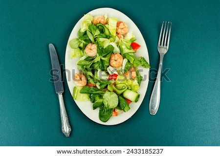 Plate with salad of fresh vegetables, herbs and shrimp. Prawns salad. Top view. Royalty-Free Stock Photo #2433185237