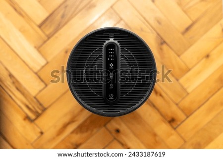 Air purifier health technology in cozy modern living room and cleaning removing dust PM2.5, Air purifier for fresh air and healthy life, Health care Air Pollution Concept. clean dust and fresh home Royalty-Free Stock Photo #2433187619