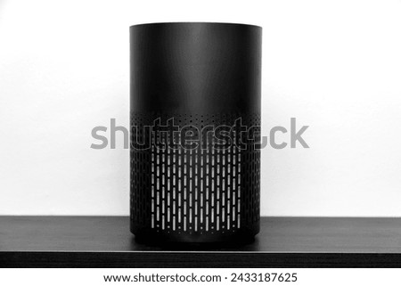 Air purifier health technology in cozy modern living room and cleaning removing dust PM2.5, Air purifier for fresh air and healthy life, Health care Air Pollution Concept. clean dust and fresh home Royalty-Free Stock Photo #2433187625