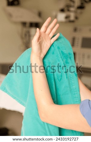 Surgeon having his hands surgically washed. A Caucasian doctor dressed in his right-hand profile with his hands full of foam and dressed in his surgical uniform.	 Royalty-Free Stock Photo #2433192727