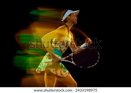 Happy woman, tennis player shouting of joy and clenched hand in fist against black studio background. Motion blur effect. Concept of sport, active lifestyles, tournaments and events, energy, movement.