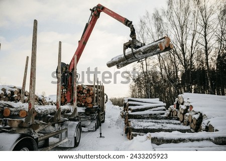 logging machinery opperating in winter Royalty-Free Stock Photo #2433205923