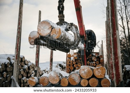 logging machinery opperating in winter Royalty-Free Stock Photo #2433205933