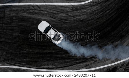 Aerial top view car drifting diffusion race drift car with lots of smoke from burning tires on speed track, Professional driver drifting car with lots of white smoke . Royalty-Free Stock Photo #2433207711