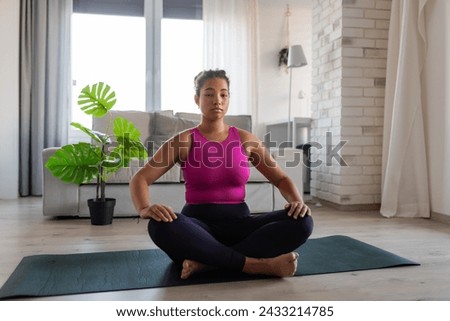 Woman resting after home workout, New Year's resolutions, healthy lifestyle, losing weight and selfcare. Concept of morning or evening exercise. Royalty-Free Stock Photo #2433214785