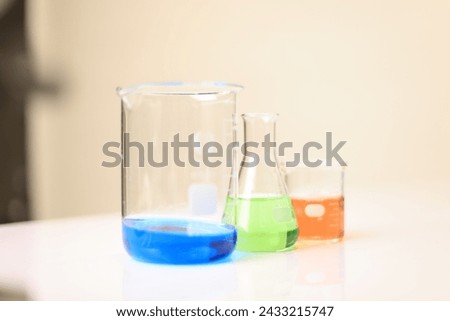 Colorful rows of laboratory test tubes and microscope with metal lens, science background. Test tube row. Concept of medical or science laboratory, close up, macro photography picture.