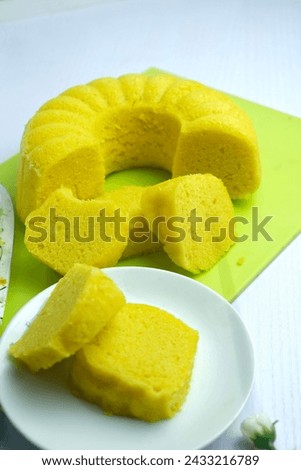 Apam Beras or steam rice cake is a traditional malay dessert. Top with grated coconut. over expose Royalty-Free Stock Photo #2433216789