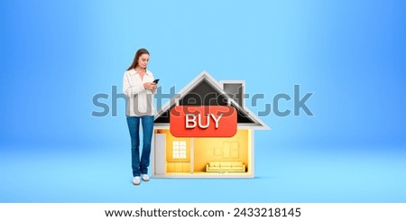 Smiling woman using smartphone, standing near small cartoon house, red tag buy on blue background. Concept of real estate, new apartment purchase and good offer